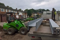 Avant unloading large steel beams